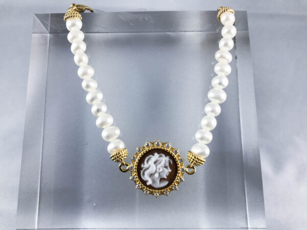 Bracciale di perle in argento dorato con un cameo che raffigura un volto